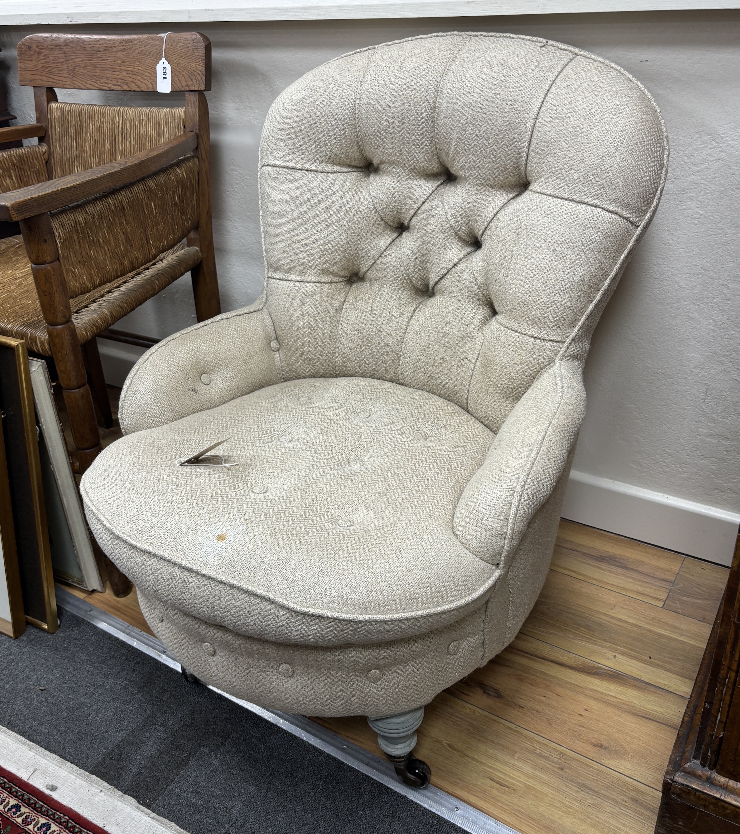 A late Victorian upholstered spoonback nursing chair, later painted legs, width 63cm, depth 72cm, height 82cm